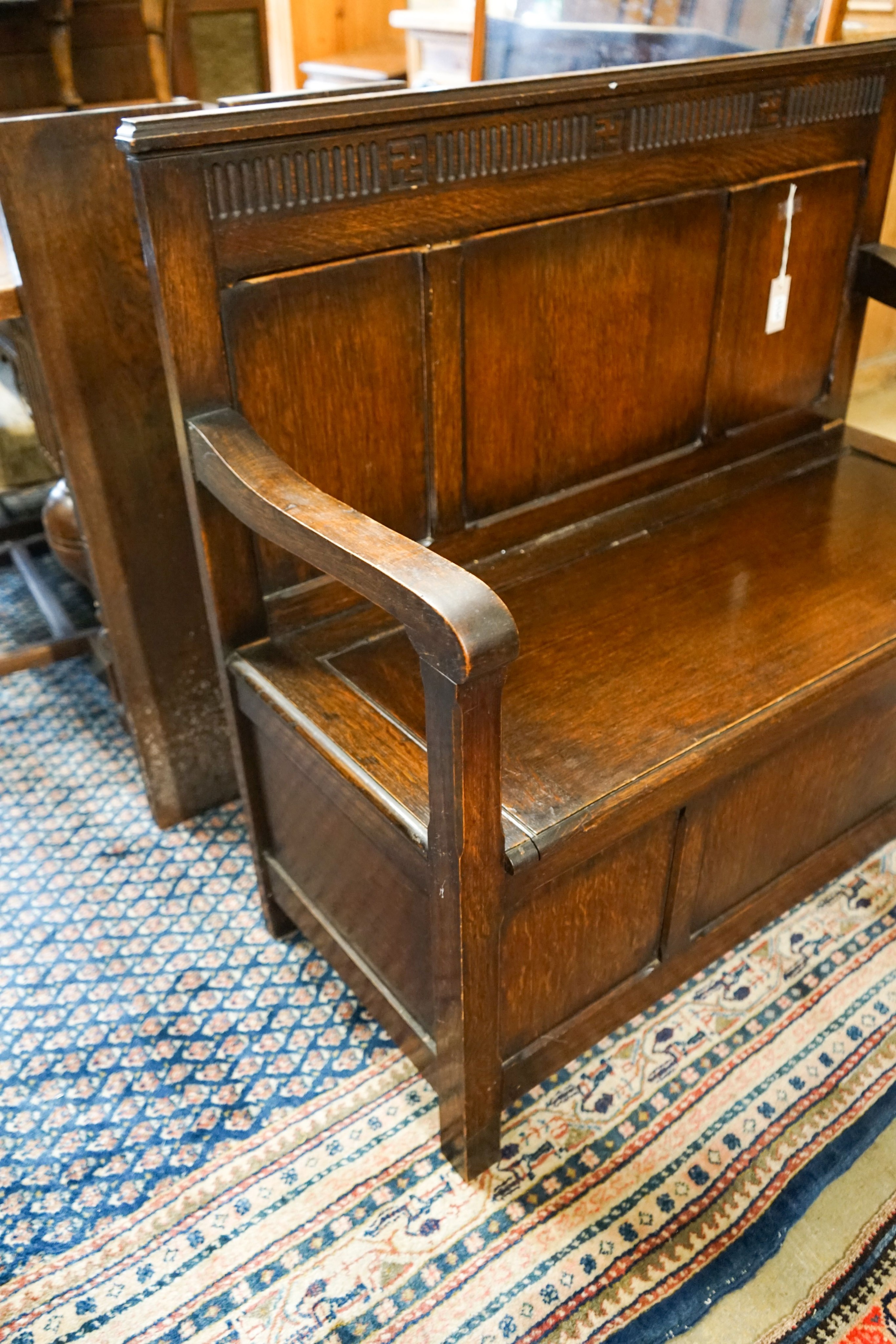 A 1920's rectangular bevelled wall mirror in oak frame, width 53cm, height 74cm together with a late Victorian wall-mounted medicine cabinet and an 18th century style panelled oak box seat settle, width 108cm, depth 45cm